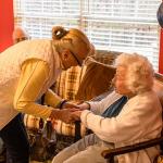 Julee receives congratulations from fellow Atria resident, Vera
