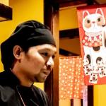 Chef at Fuji Ya and beckoning cat banner